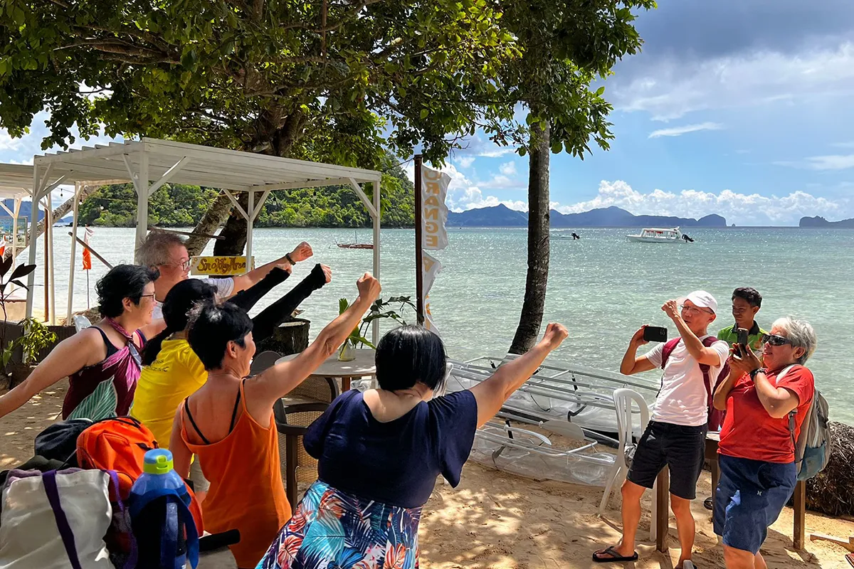 Team celebrating on the beach — El Nido, Philippines